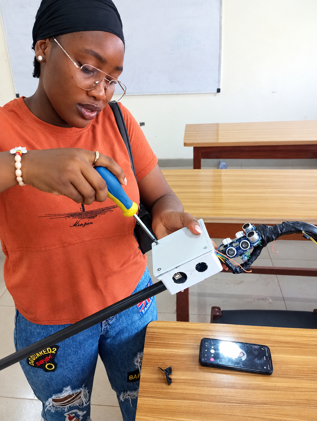 A member being trained on building a smart walking stick